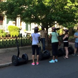 Guests enjoying the view of a huge white house in Charlotte from their Segway PTs