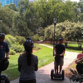 Guests riding their Segway PTs through a park in Charlotte, NC