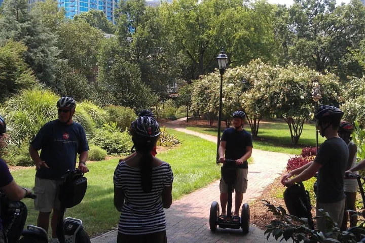 Guests riding their Segway PTs through a park in Charlotte, NC