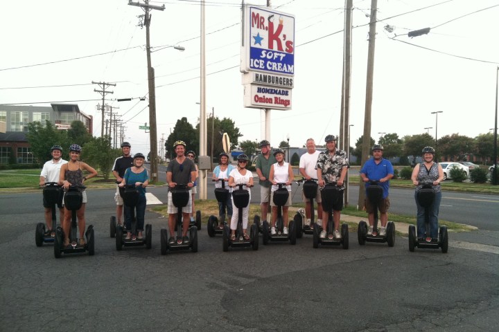 Guests smiling on Segways at Mr.K's soft ice cream