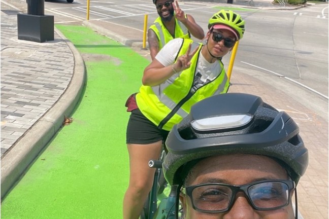 a woman wearing a helmet smiling at the camera