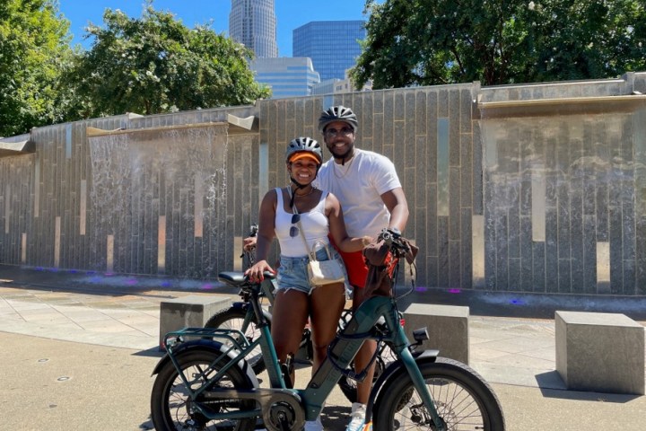 a man riding a motorcycle in front of a building