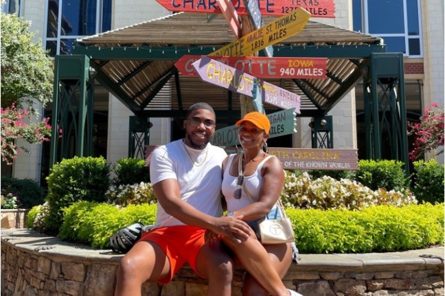 a person holding a frisbee in front of a building
