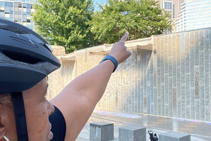 a man with a bicycle in front of a building