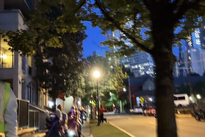 a group of people riding motorcycles on a city street