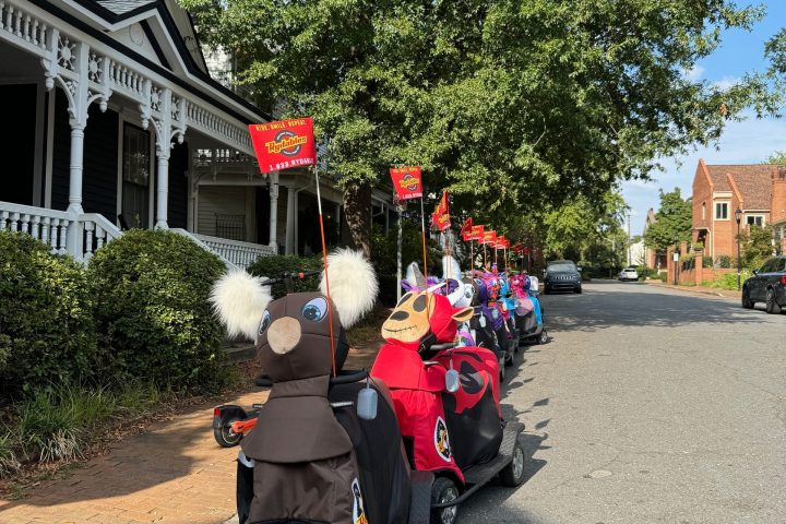 a group of people sitting on the side of a road