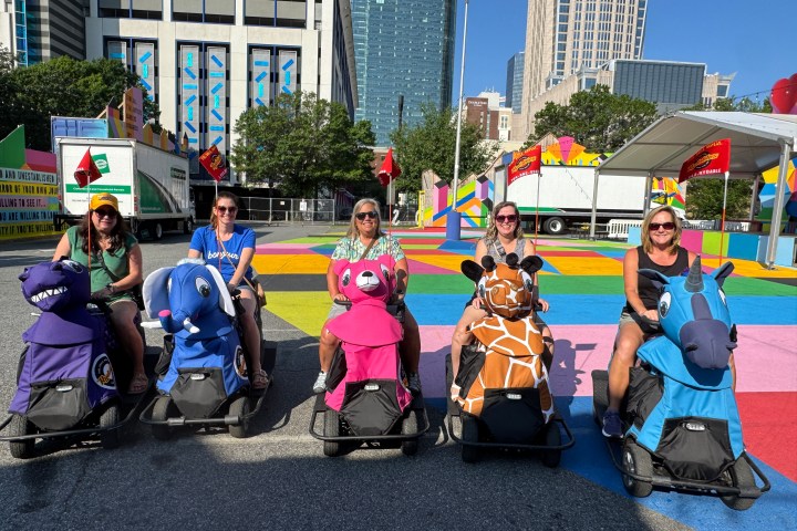a group of people standing in a parking lot