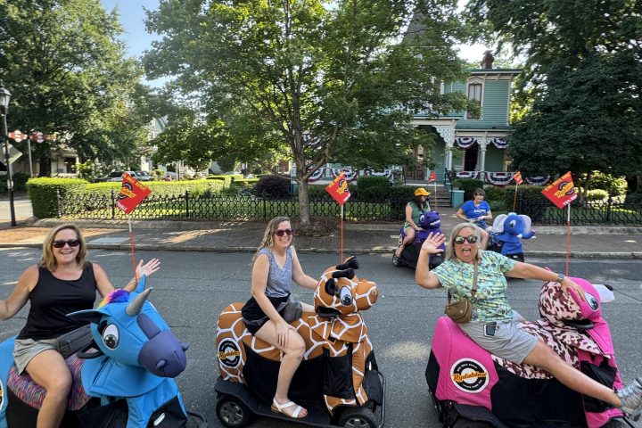 a group of people sitting in a parking lot