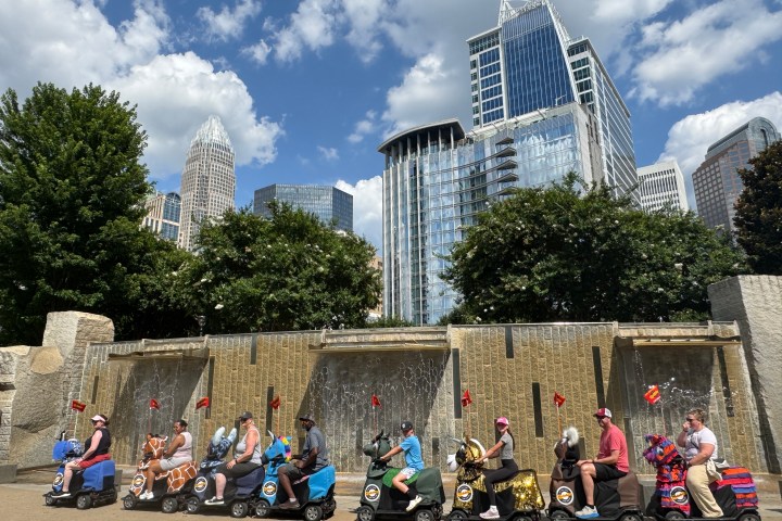 a group of people sitting on the side of a building