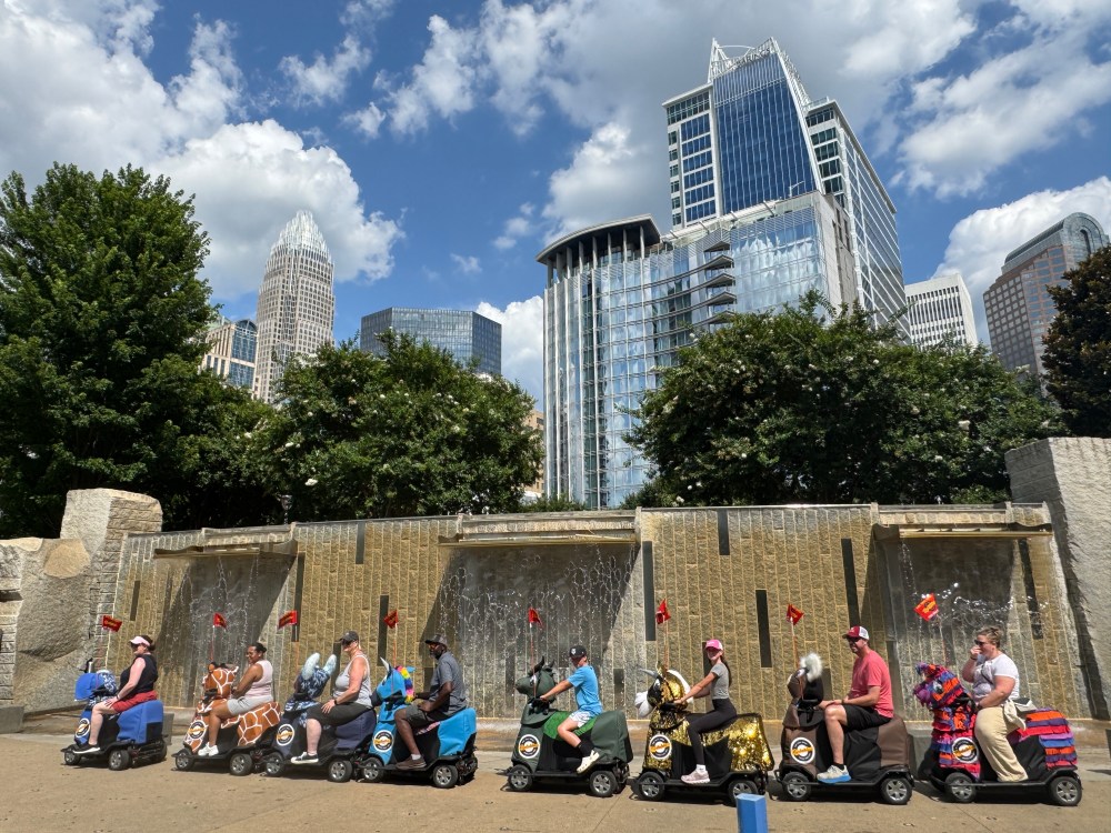 a group of people sitting on the side of a building